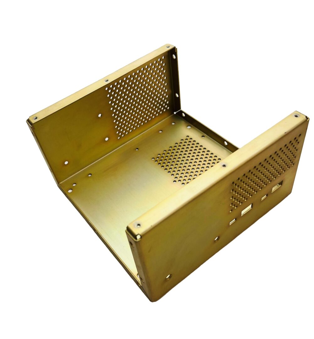 A gold metal box with a grill on top of it.