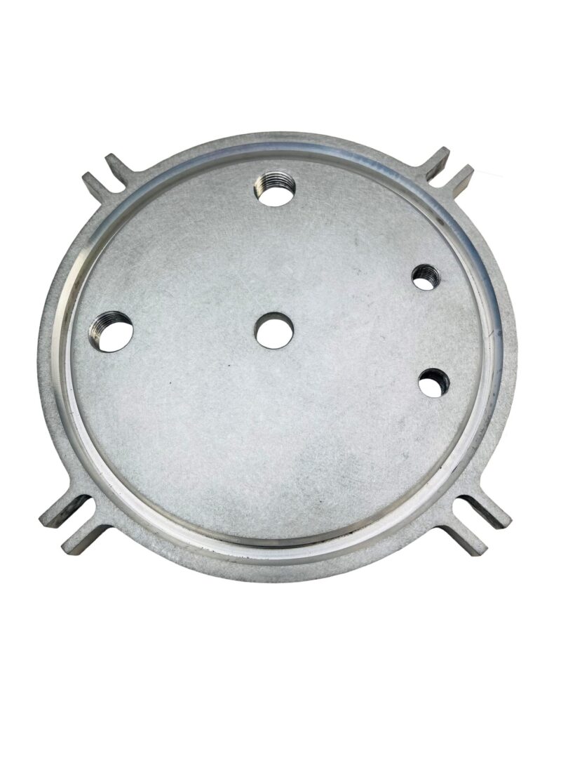 A metal plate with six holes on it.